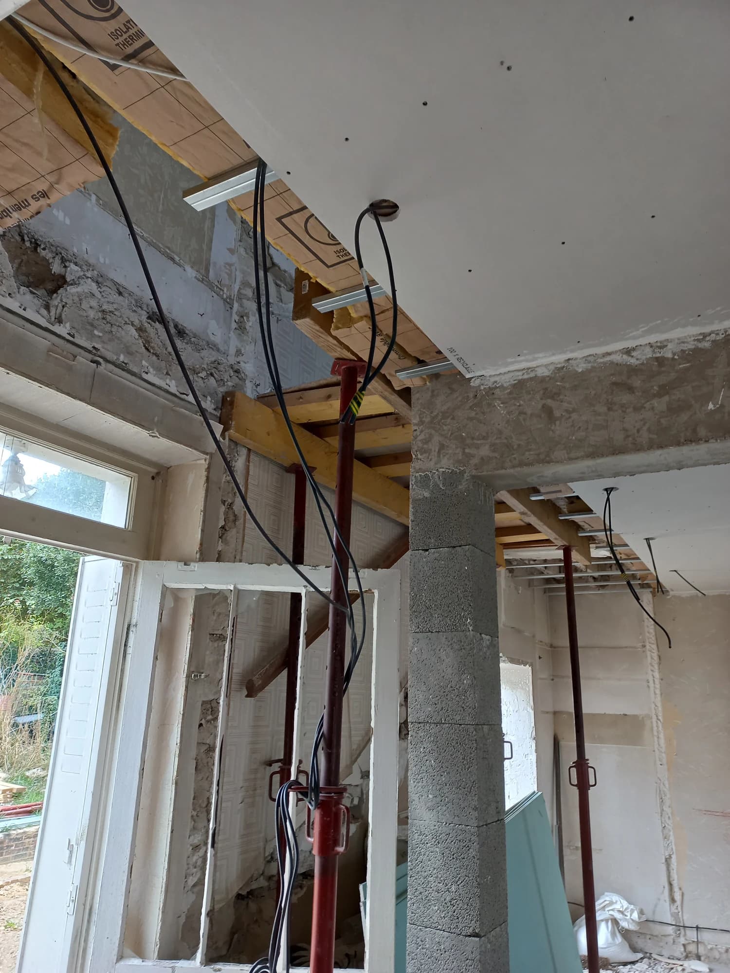 Plafond en cours de finition et réseaux apparents pendant la rénovation intérieure à Pontoise.